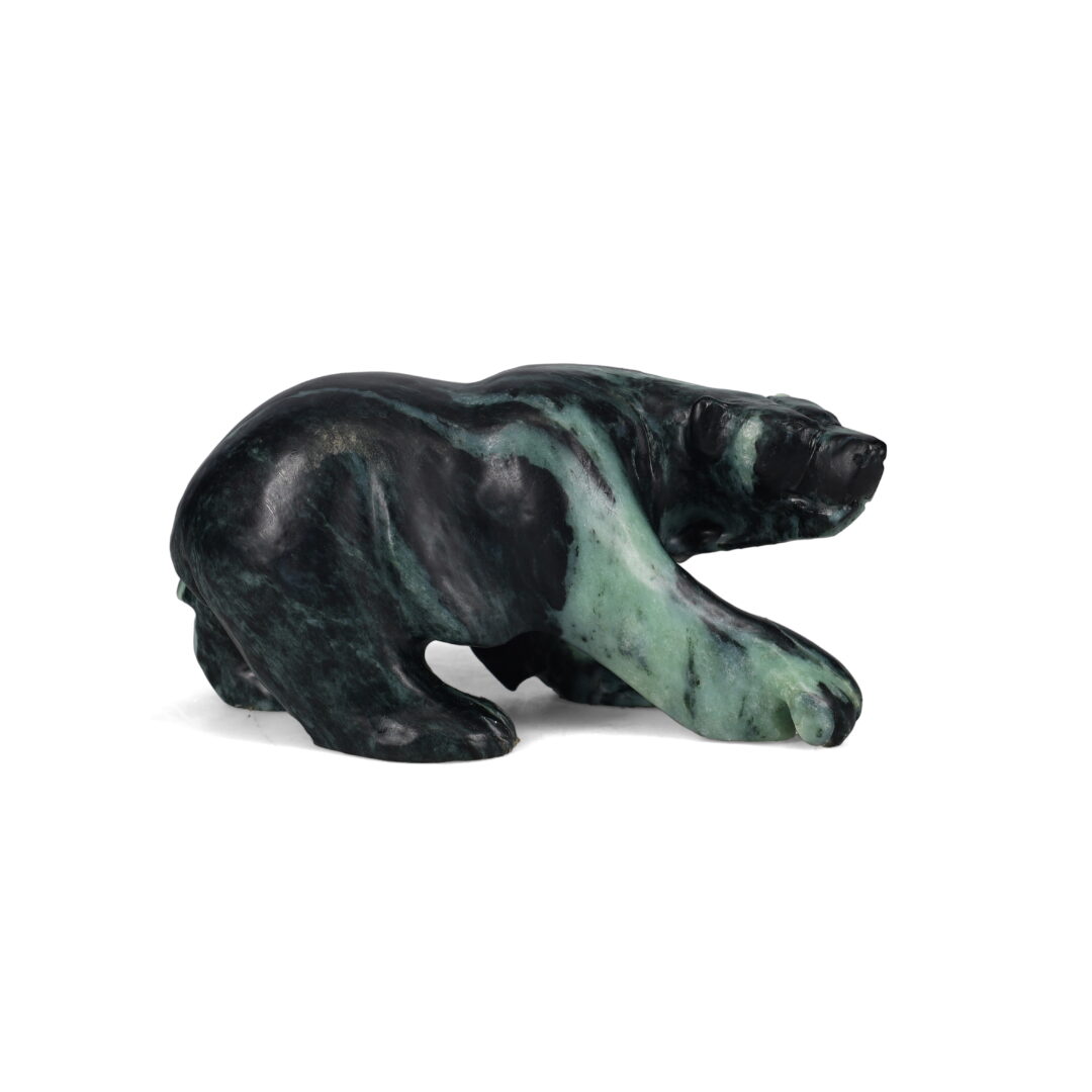 One original hand-carved sculpture by Inuit artist, Jonasie Faber. One walking bear carved out of soapstone.
