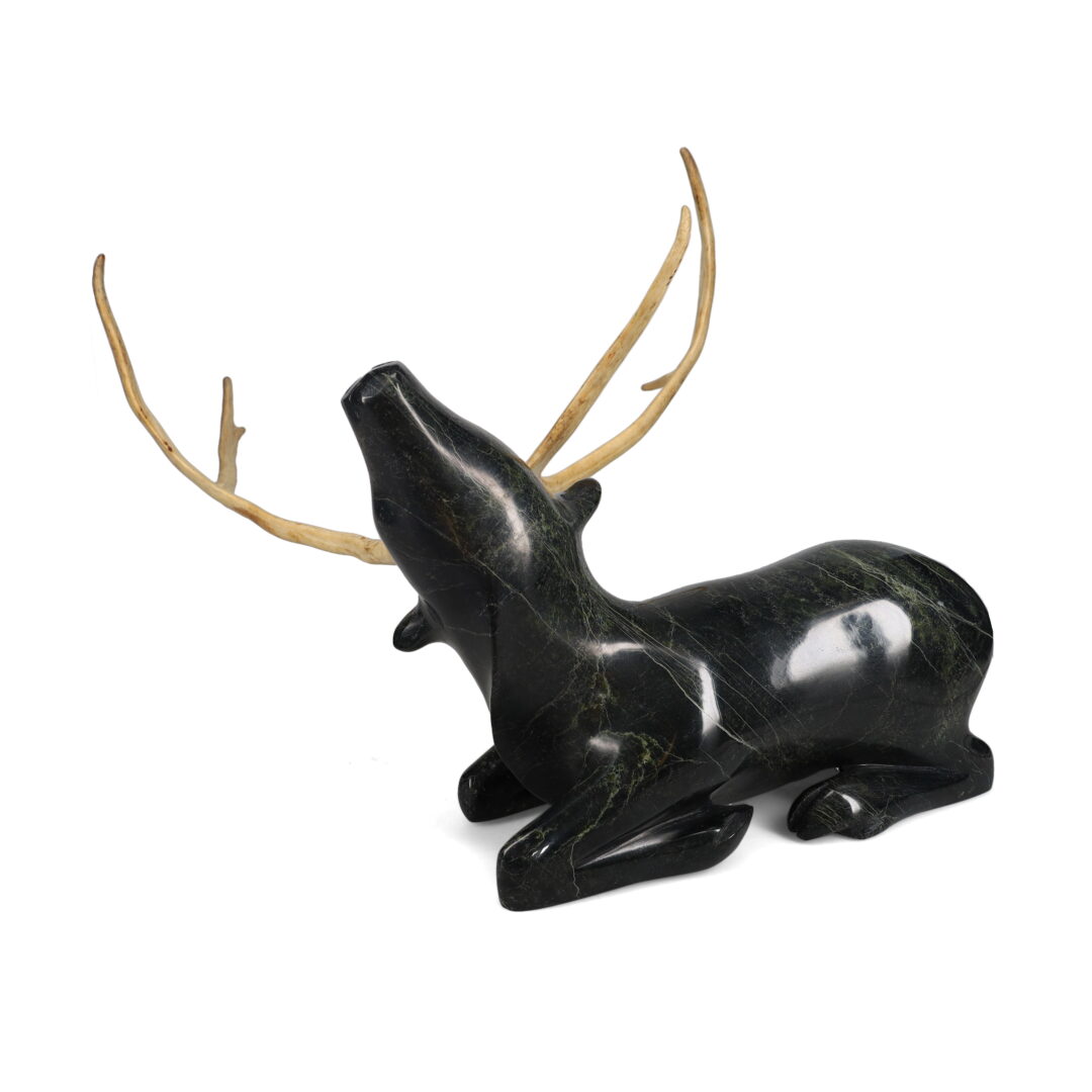 One original hand-carved sculpture by Inuit artist, Sii Ashoona. One caribou carved out of serpentine and antler.