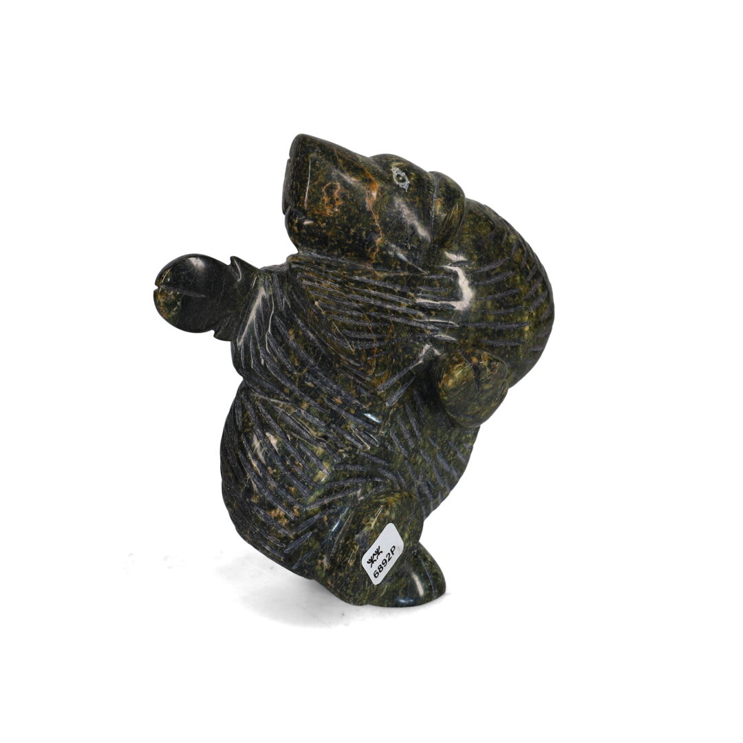 One original hand-carved sculpture by Inuit artist, Pitseolak Qimirpik. One dancing muskox carved out of serpentine.