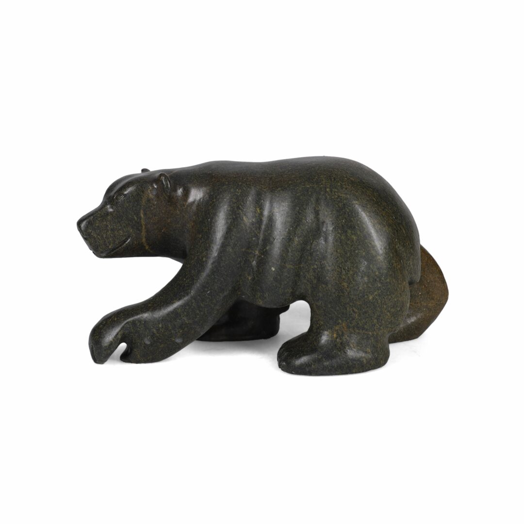 One original hand-carved sculpture by Inuit artist, Jonasie Faber. One walking bear carved out of soapstone.