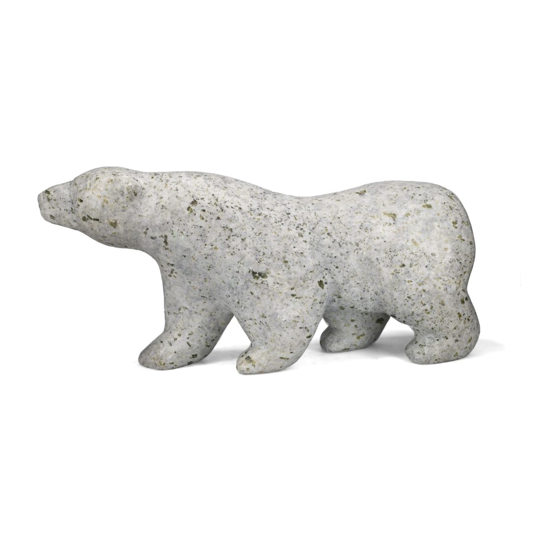 One original hand-carved sculpture by Inuit artist, Mosese Kolola. One walking bear carved out of serpentine.