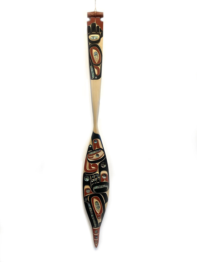 One original hand-carved paddle by Nuuchahnulth artist, Moy Sutherland Jr. One paddle carved out of cedar wood, and abalone