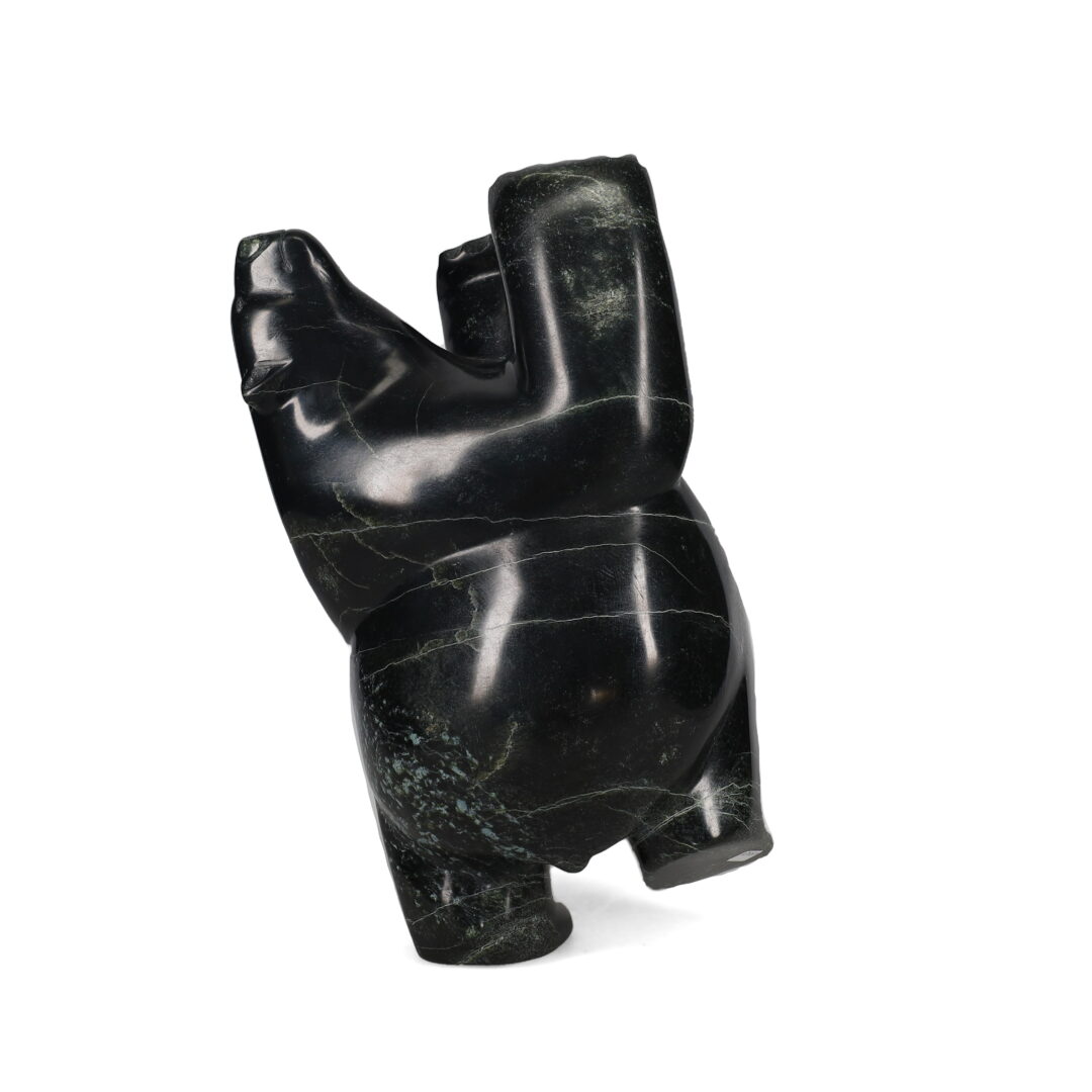 One original hand-carved sculpture by Inuit artist, Isaaci Petaulassie. One dancing bear carved out of serpentine.