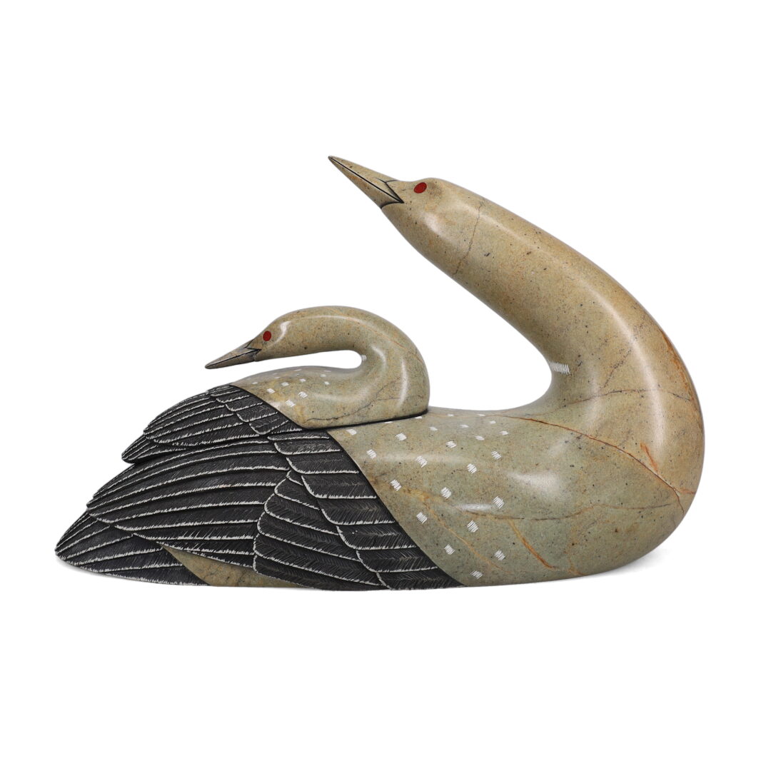 One original hand-carved sculpture by Iroquois artist, Cyril Henry. One loon and chick carved out of soapstone.
