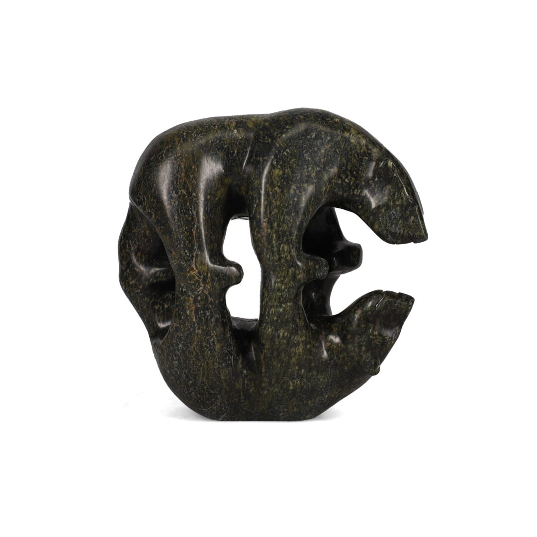 One original hand-carved sculpture by Inuit artist, Tony Oqutaq. One mirror bear carved out of serpentine.