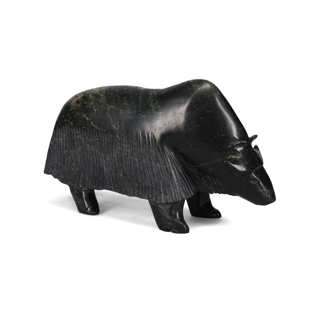 One original hand-carved sculpture by Inuit artist, Noah Jaw. One musk-ox carved out of dark serpentine stone.