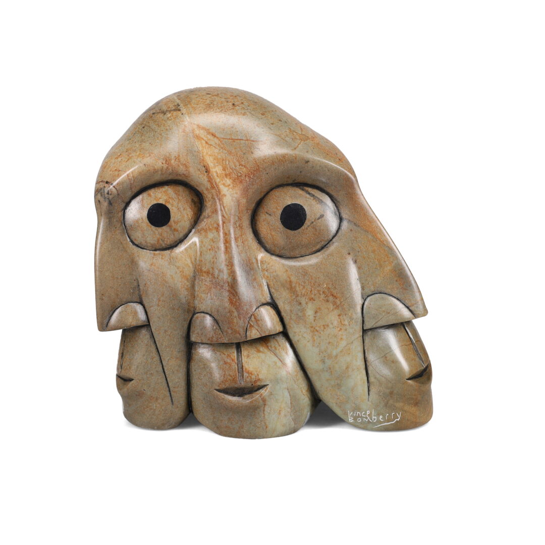 One original hand-carved sculpture by Iroquois artist, Vince Bomberry. Several joined faces, carved out of soapstone.