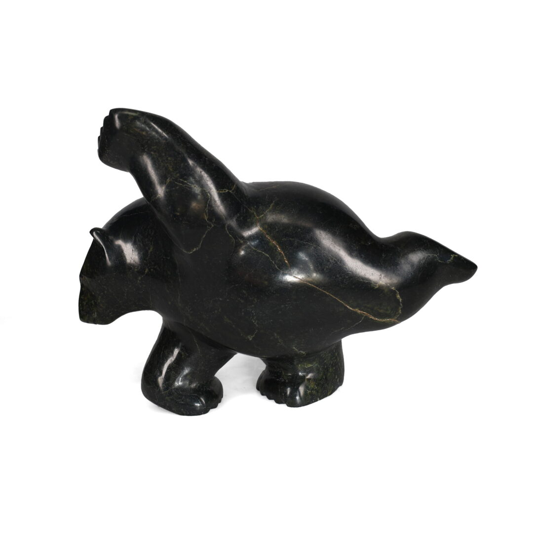 One original hand-carved sculpture by Inuit artist, Etidloie Adla. One dancing bear carved out of serpentine.