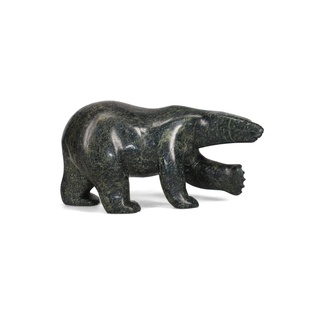 One original hand-carved sculpture by Inuit artist, Quaraq Nungusuitok. One bear carved out of serpentine stone.