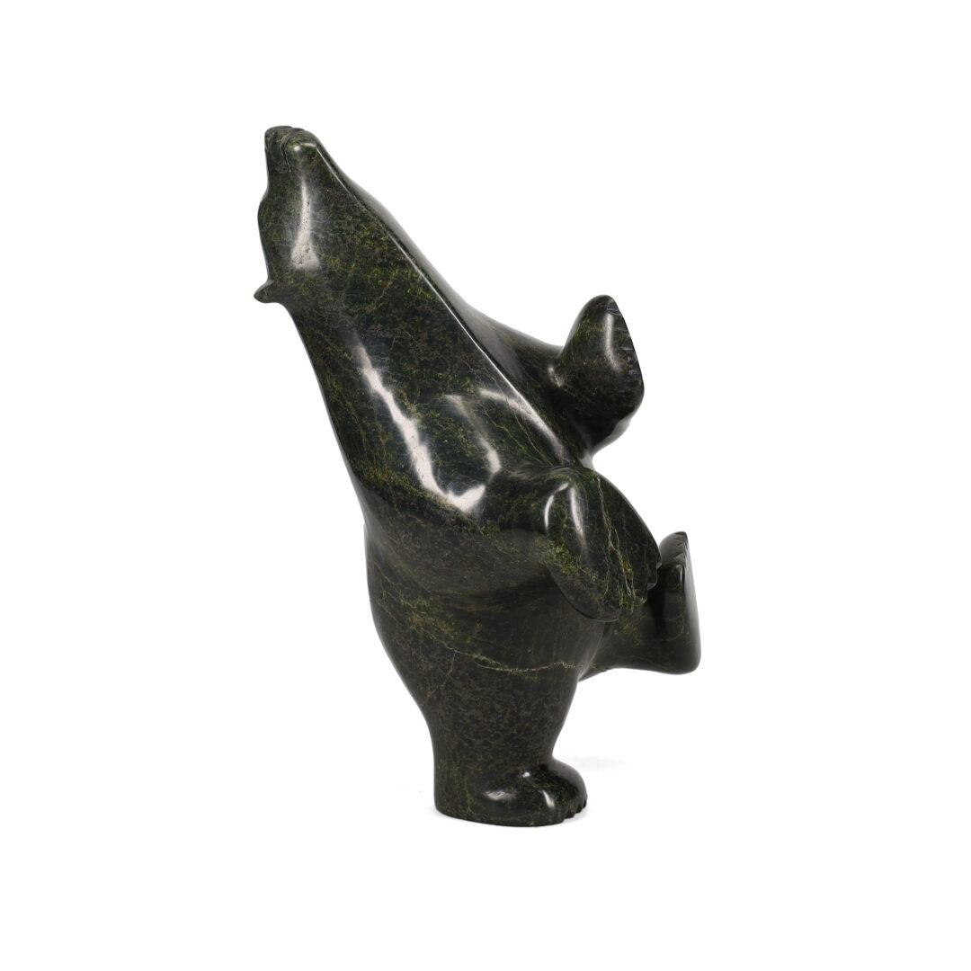 One original hand-carved sculpture by Inuit artist, Etidloie Adla. One dancing bear carved out of serpentine.