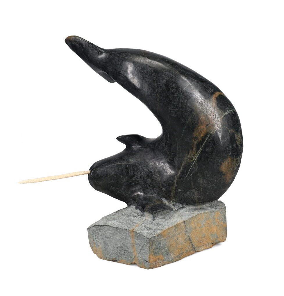 One original hand-carved sculpture by Inuit artist, Jaco Ishulutak. One narwhal carved out of serpentine and antler.