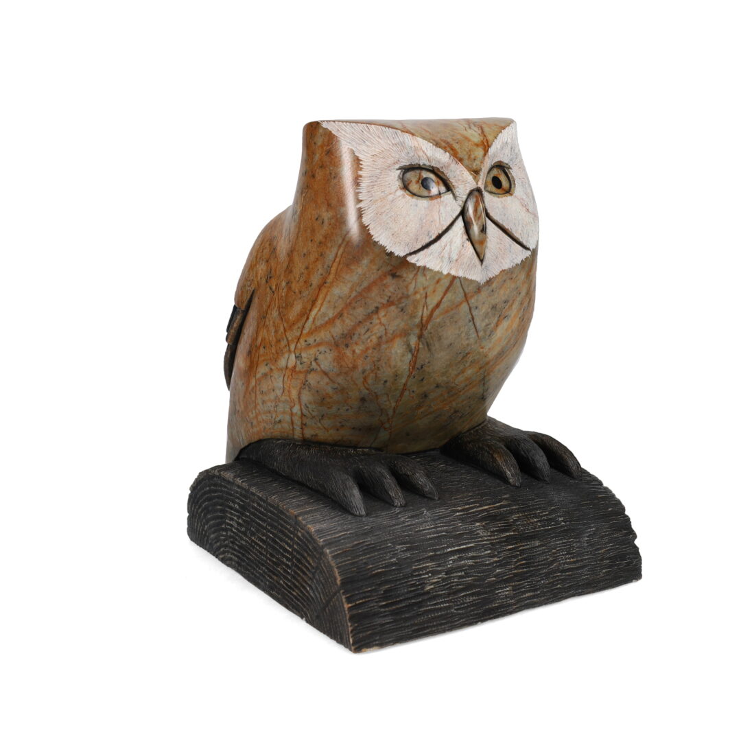 One original hand-carved sculpture by Iroquois artist, Cyril Henry. One owl sitting on a log carved out of soapstone.