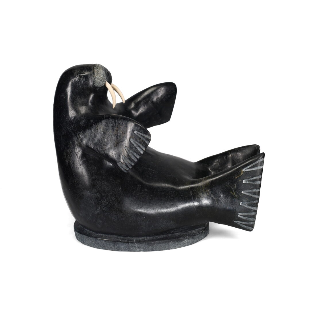 One original hand-carved sculpture by Inuit artist, Manasie Maniapik. One walrus carved out of serpentine.