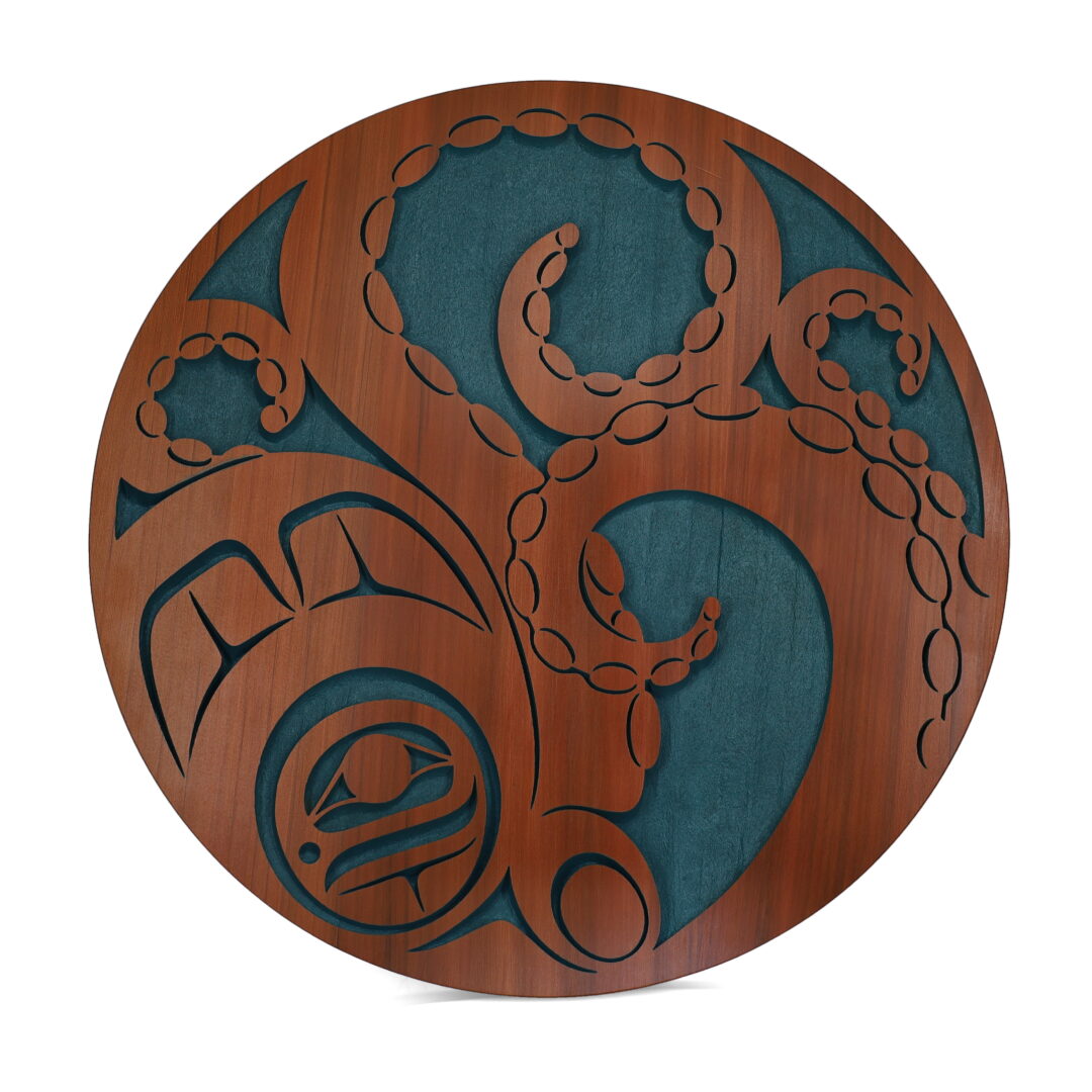 One cedar wood panel carved by the Nuxalk artist, Nusmata. One wooden panel depicting an octopus, painted blue.