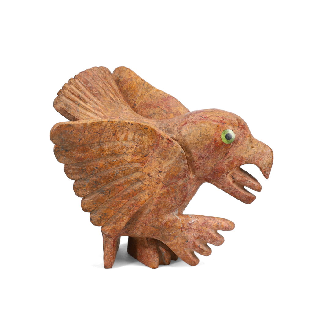 One original hand-carved sculpture by Inuit artist, Toonoo Sharky. One falcon carved out of red basalt and serpentine.