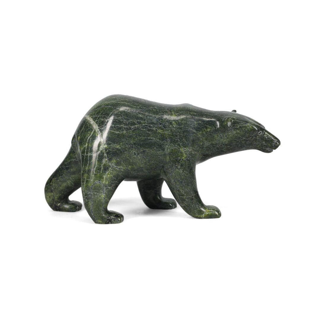 One original hand-carved sculpture by Inuit artist, Timothy Pee. One walking bear carved out of serpentine.