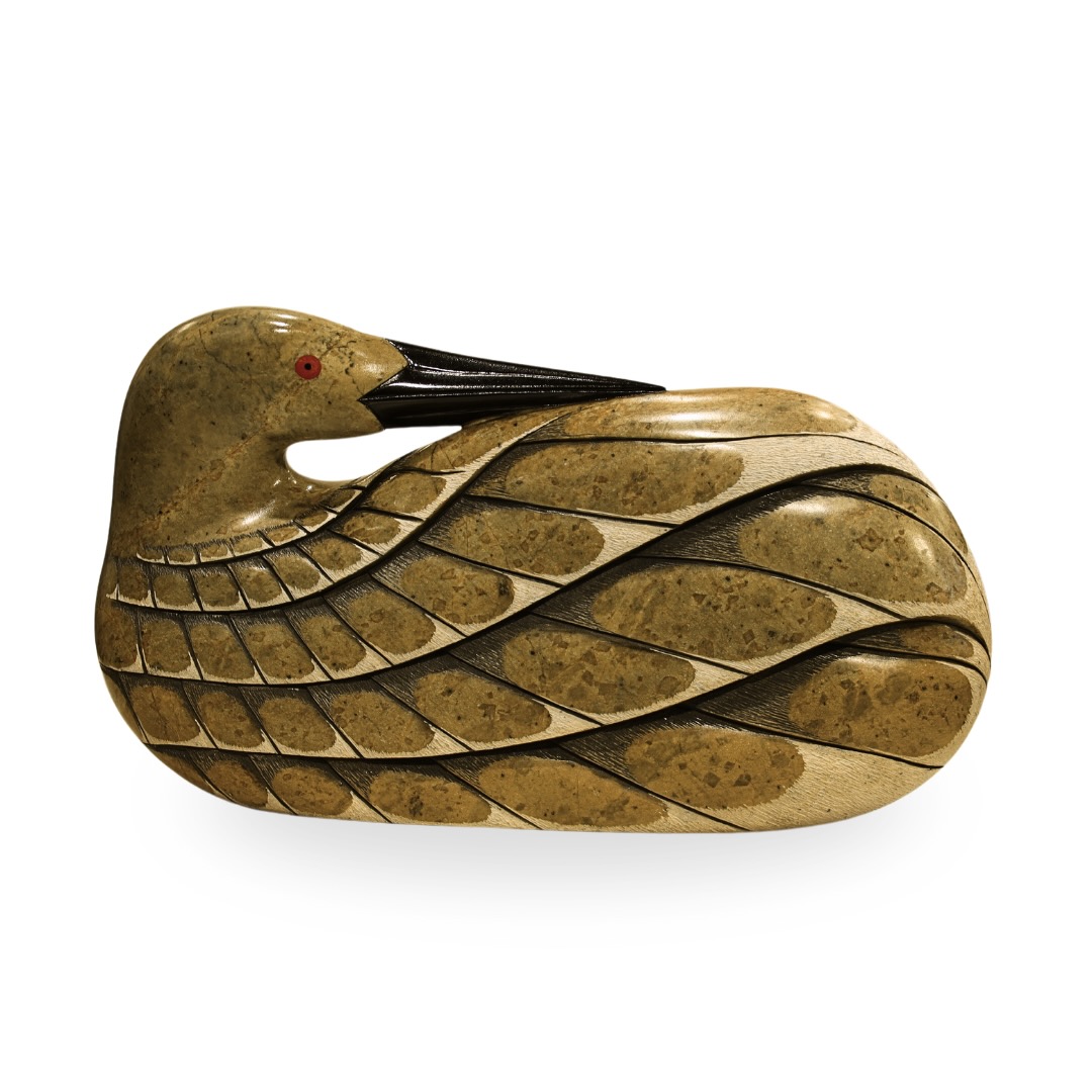 One original hand-carved sculpture by Iroquois artist, Eric Silver. One swimming loon carved out of soapstone.