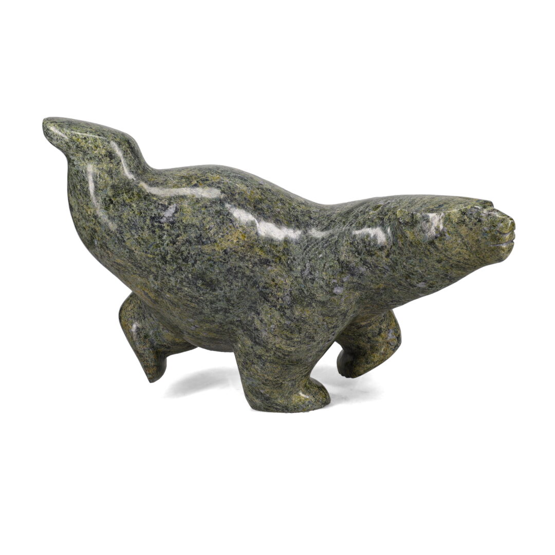 One original hand-carved sculpture by Inuit artist, Etidloie Adla. One diving bear carved out of serpentine.