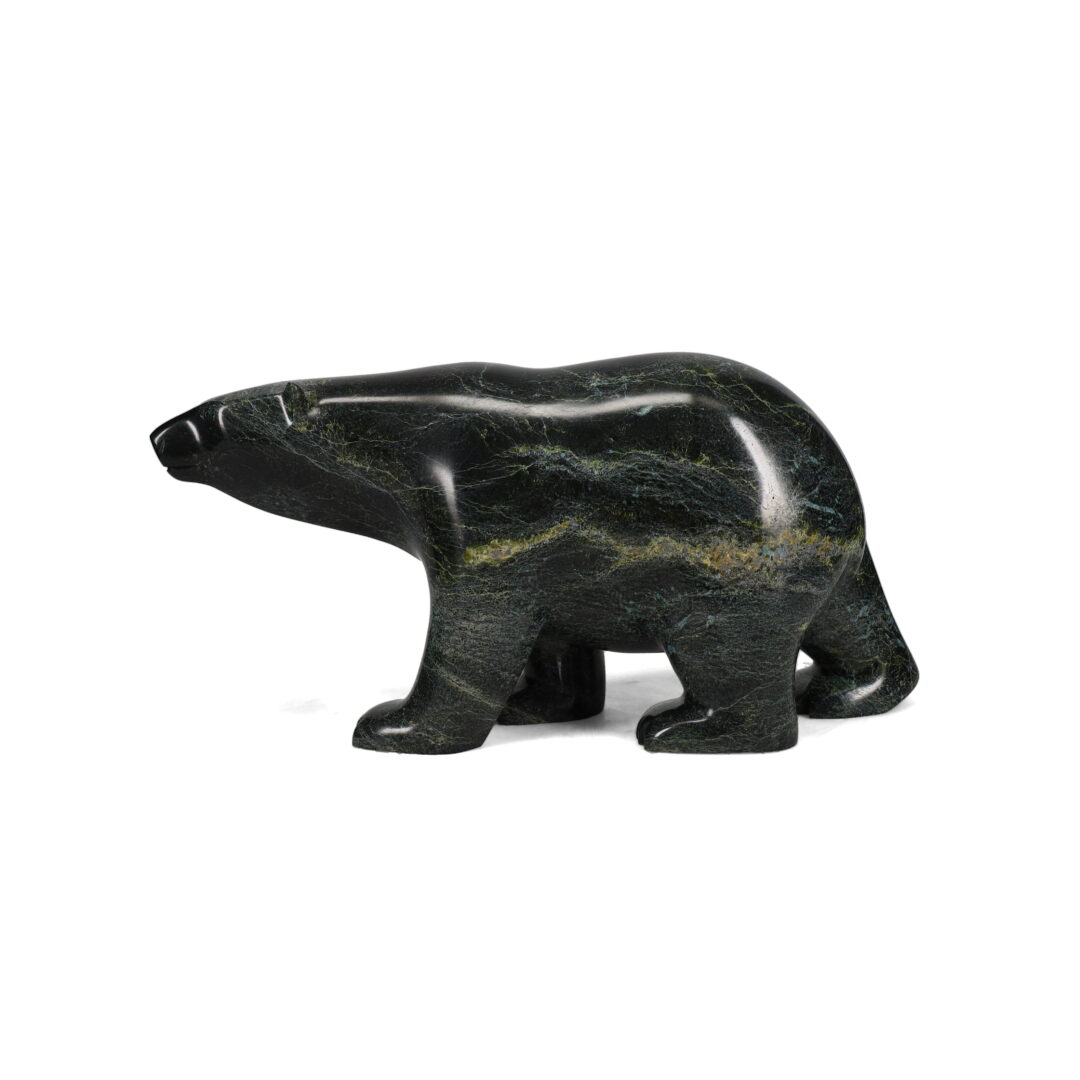 One original hand-carved sculpture by Inuit artist, Ashevak Adla. One walking bear carved out of serpentine.