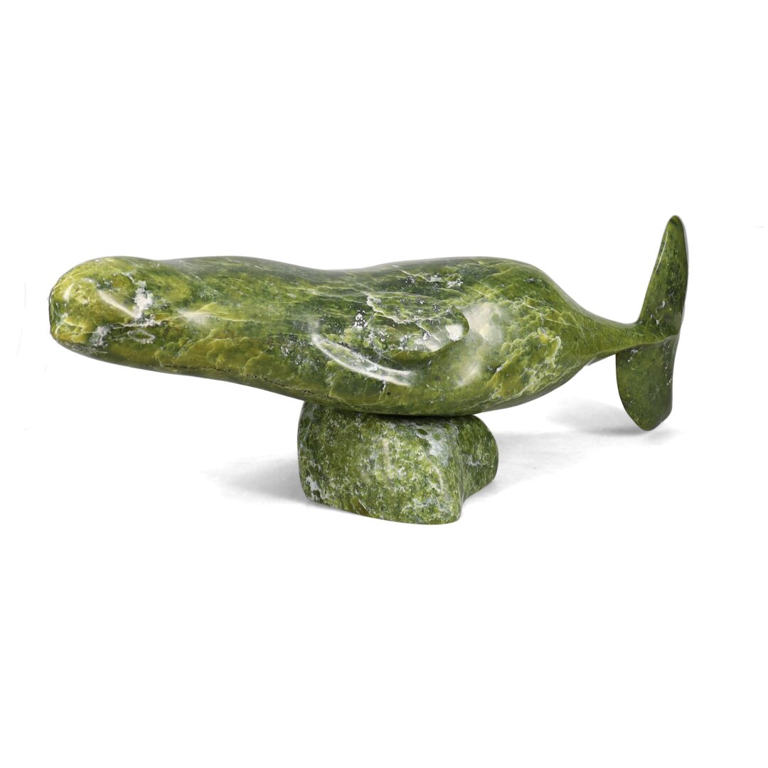 One original hand-carved sculpture by Inuit artist, Moe Kolola. One beluga carved out of green serpentine stone.